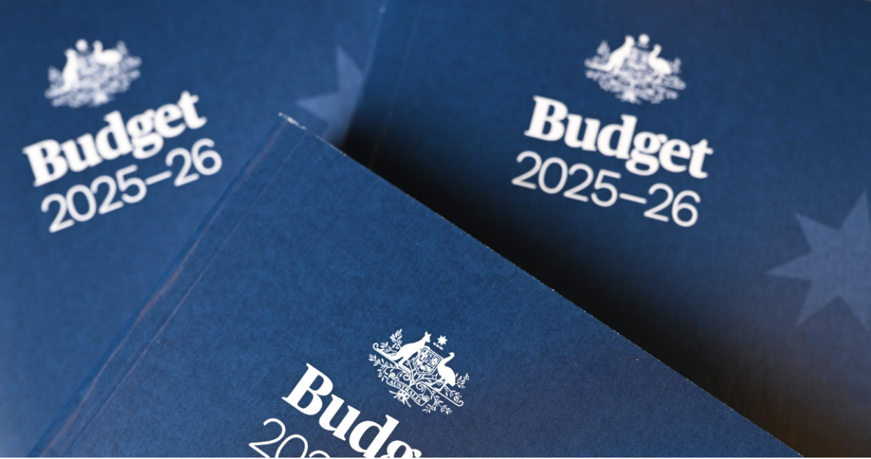 Blue booklets titled "Federal Budget 2025-26" with an emblem on the cover, highlighting key initiatives in the health sector and aged care.